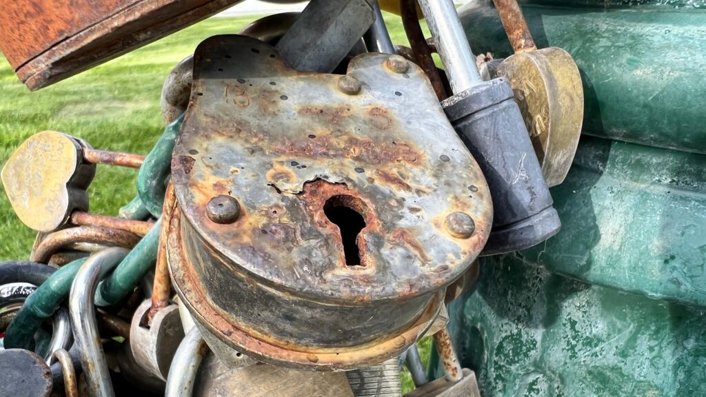 Old Rusty Security Lock With Keyhole Surrounded By Locks