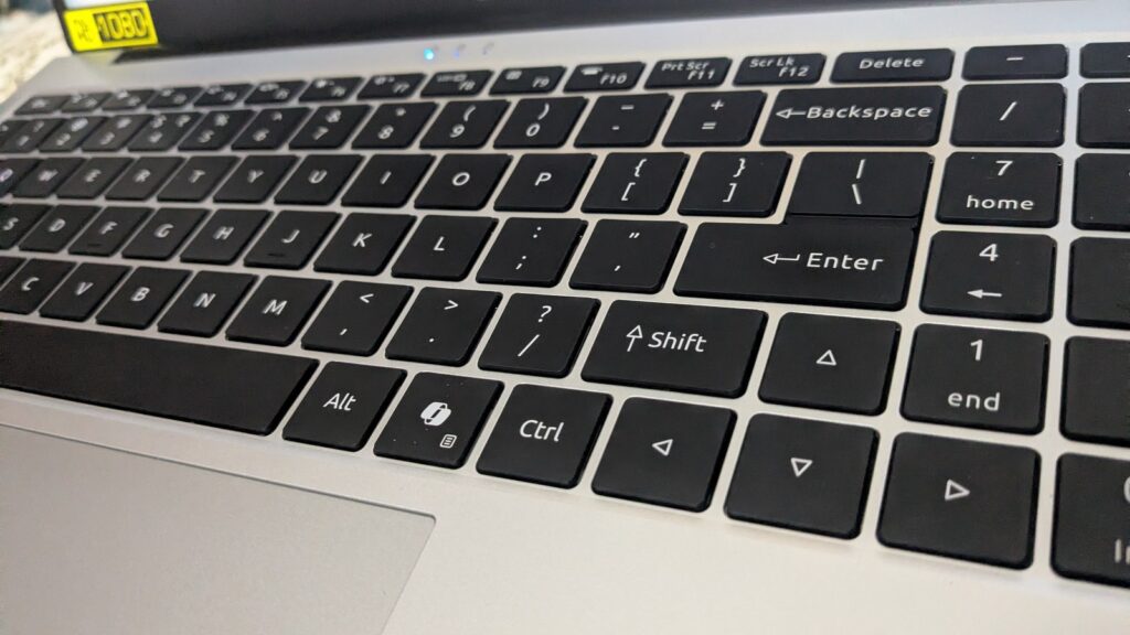 A picture focused on a keyboard showing all the alphabet, digits, and numbers.