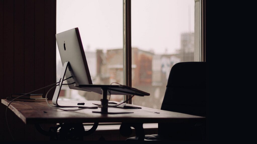Quiet computer workstation beside a large window