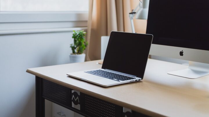 Laptop on a neat modern desk with desktop monitor