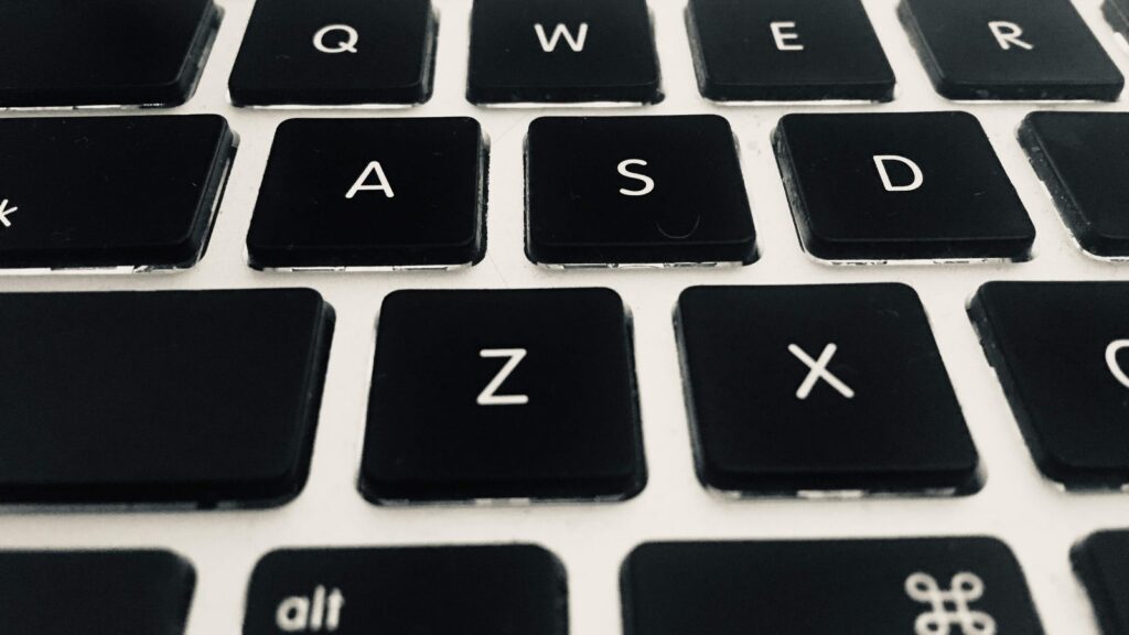Close-up photograph of a black keyboard with white letters.