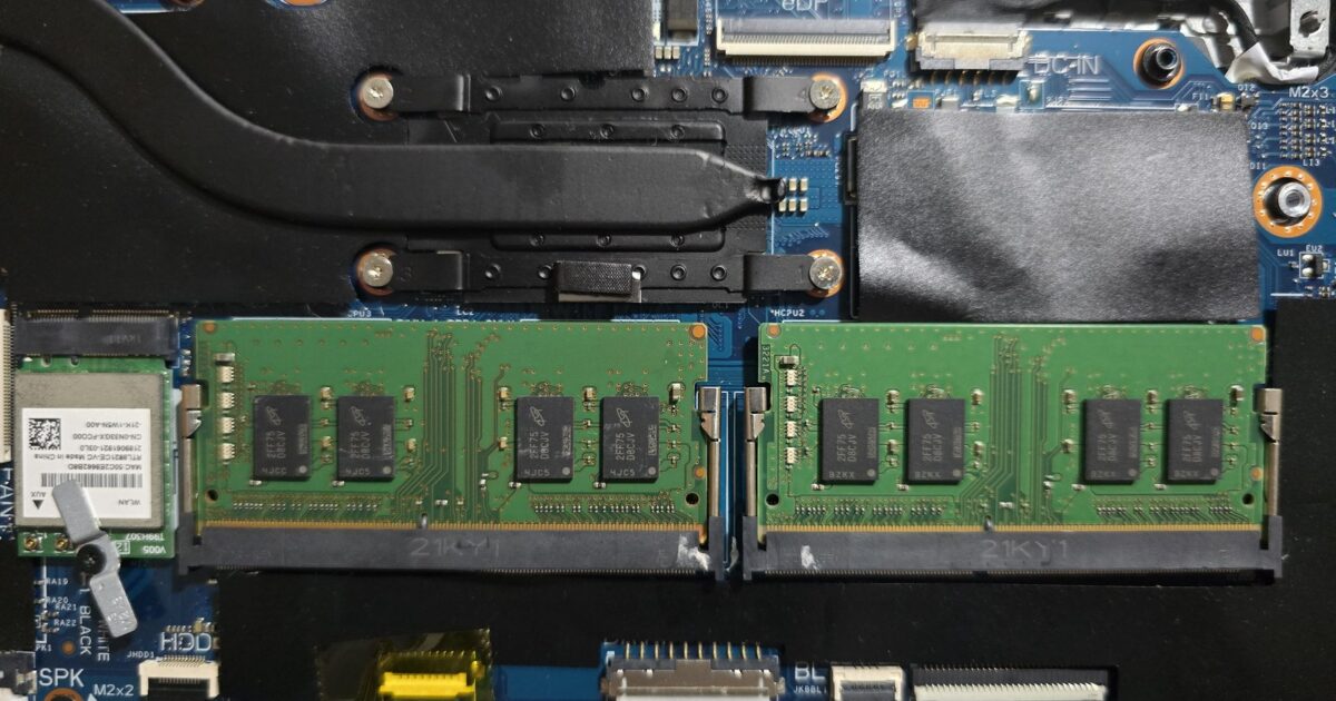 Two SODIMM RAM modules installed on a laptop motherboard with nearby cooling components.
