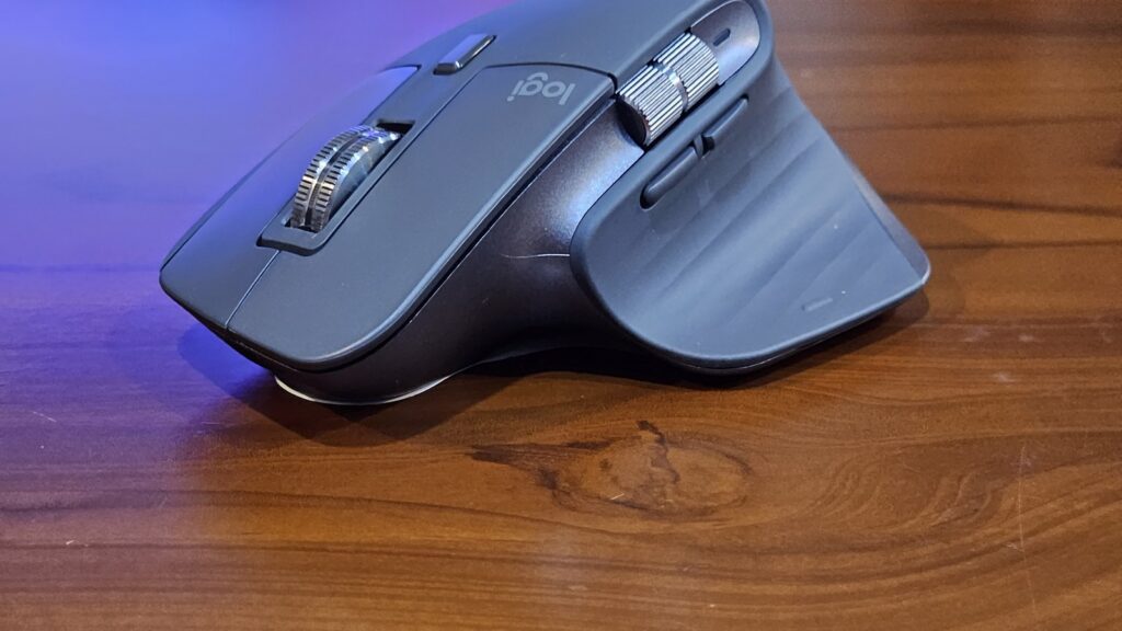 A computer mouse resting on a wooden table.