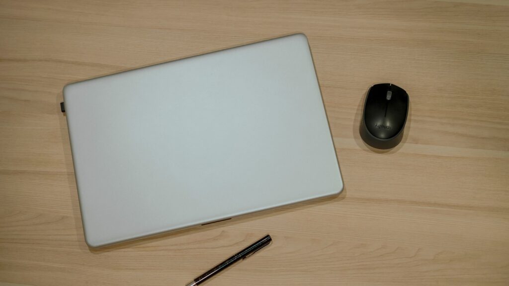 Top view of laptop, Mouse and Pen on wooden table