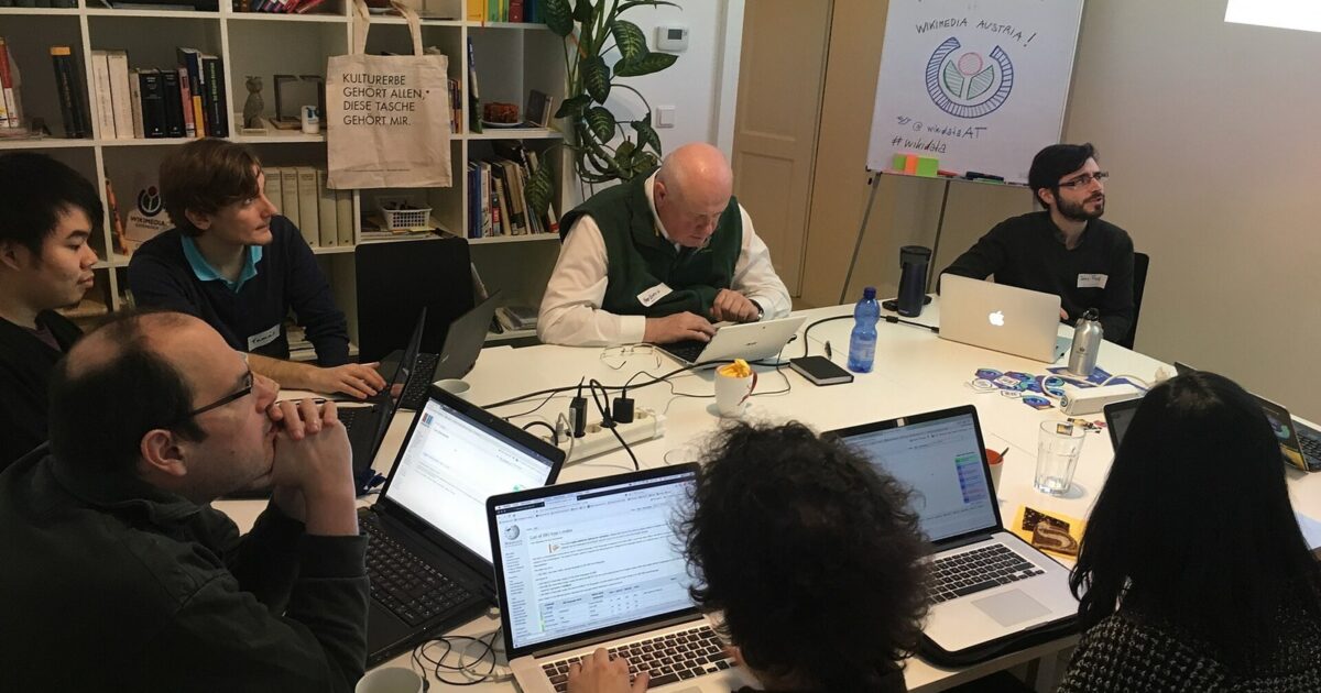 Group working together on laptops during a collaborative technology workshop