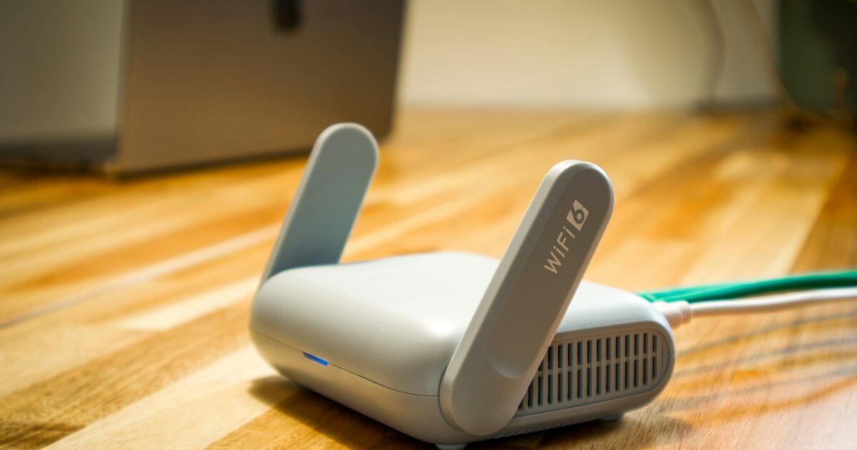 Wireless router on a wooden desk in a modern workspace